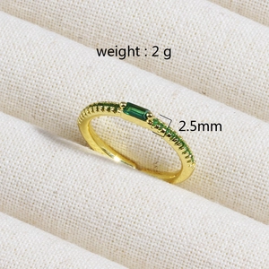 Detailed macro view of 18K gold plated ring with emerald zircon and 2g weight mark