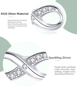 Macro detail of S925 sterling silver infinity earrings with cubic zirconia claw setting