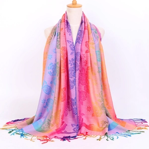 Detail of colorful gradient floral jacquard pattern and soft fringe on the scarf