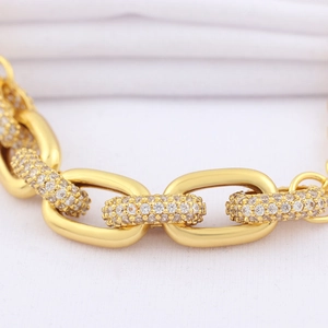 Macro shot of gold plated hip hop link bracelet featuring pavé set cubic zirconia