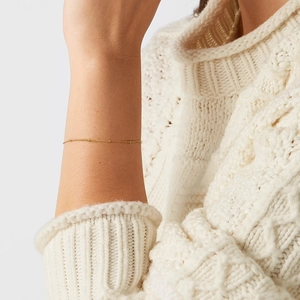 Elegant gold beaded S925 sterling silver chain bracelet worn on a model's wrist