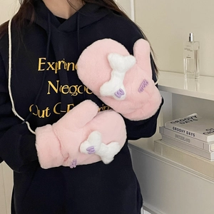 Close-up of plush pink mittens featuring white bone decor and purple 'W' embroidery