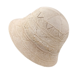 Macro detail of breathable hollow knit pattern on beige summer sun bucket hat