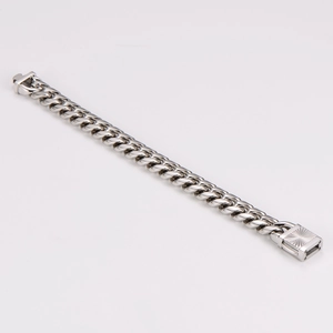 Detail of silver steel Cuban link bracelet showing the classic clasp and dense chain links