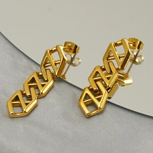 Detail of gold geometric chain earrings showing the S925 silver hallmark and metal butterfly back
