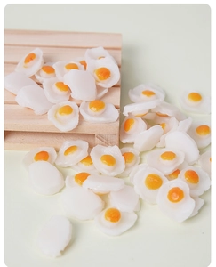 Macro view of miniature resin fried eggs for dollhouse DIY crafts and miniature food scenery
