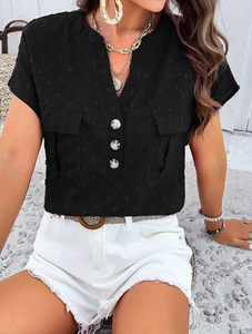 Detail of black V-neck textured shirt with three buttons and dual chest pockets