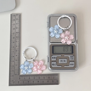 Close-up showing the size and 8.91g weight of resin cherry blossom flower keychains