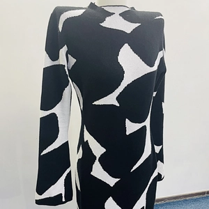 Detail of slim fit knitted dress with geometric black and white contrast pattern