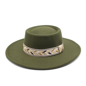 Detail of olive green wool felt boater hat featuring a decorative geometric woven ribbon
