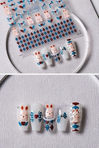 5D embossed nail art stickers with cute bunny and bow designs on white nails