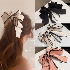 Elegant satin bow banana hair clips set in black, cream, and pink with dark edging