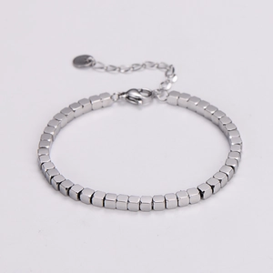 Detail of minimalist stainless steel bracelet featuring small cubic beads and lobster clasp