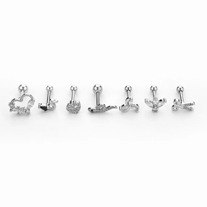 Macro detail of seven stainless steel cartilage studs with heart and floral zircon shapes