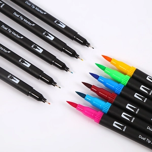 Dual tip markers set with fine and brush nibs for coloring and calligraphy on white background