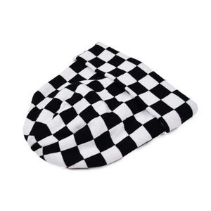 Close-up of classic black and white checkerboard knit pattern on a winter beanie hat