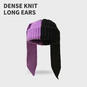 Two-tone purple and black knitted beanie featuring long rabbit ears for a cute winter look