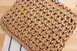 Close-up of hand-woven straw bag texture featuring tight bohemian weaving craftsmanship
