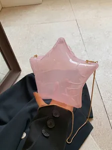 Handheld transparent pink star-shaped acrylic crossbody bag with elegant gold metal chain