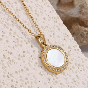 Close-up of 18K gold plated shell pendant necklace with sparkling zircon halo detail