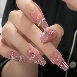 Detailed view of pink gradient coffin nails with luxury rhinestones and glitter finish