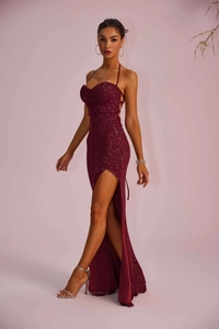 Detail of elegant dark red sequin evening dress with backless design and high side slit