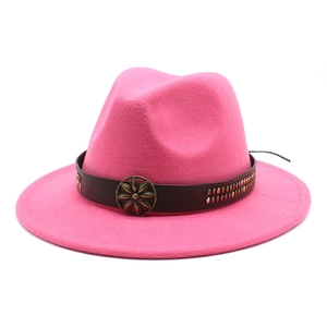 Detail of bright pink wool fedora with brown leather band and metal flower buckle