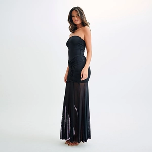 Detailed view of backless tube dress with black mesh stitching and elegant sheer texture