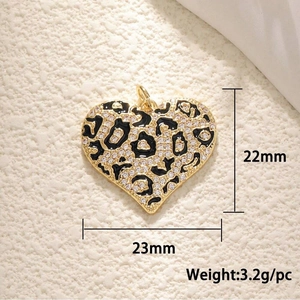 Detail view of heart pendant with leopard pattern and dimensions 23mm by 22mm