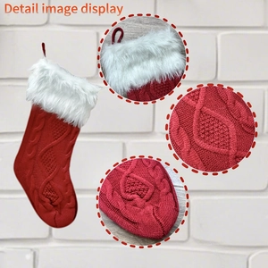 Detail view of red knitted Christmas stocking with white faux fur trim and cable patterns