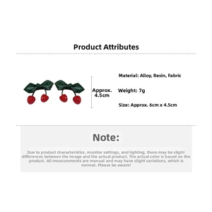 Detailed view of 6cm cherry bow hair clip made of alloy resin and green fabric