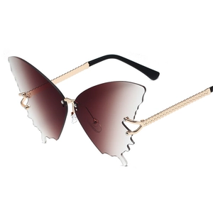 Frameless butterfly sunglasses with brown gradient lenses and gold textured temples