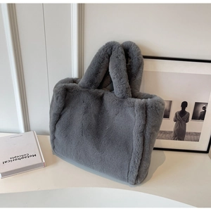 Detailed close-up of the plush gray faux fur texture on a large capacity tote bag