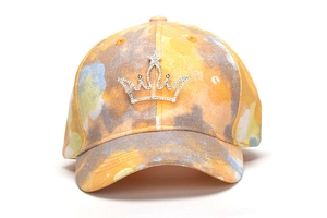 Detail of rhinestone crown on colorful tie-dye baseball cap with sparkling star accent