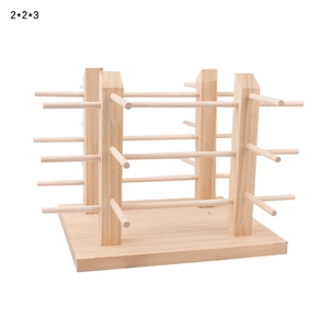 Detail of multi-tier wooden eyewear display stand with four pillars on natural wood base