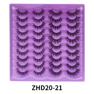 20 Paar gemischte flauschige künstliche Wimpern, kurzes und dichtes Design auf lila Schale.
