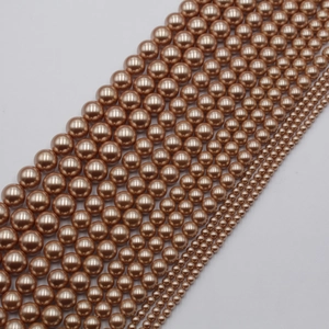 Macro shot of assorted champagne gold glass pearl beads in various sizes for jewelry
