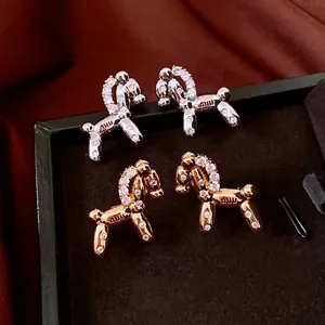 18k gold plated balloon dog stud earrings with white zircon stones in a jewelry box