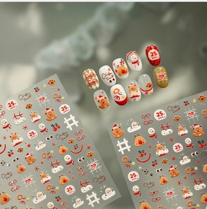 Detail view of 3D Christmas nail art stickers featuring teddy bears, elk and snowmen