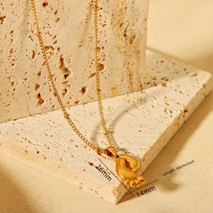 Detailed view of gold foot pendant necklace with 26x14mm size and 45cm ball chain
