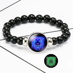 Detailed view of Leo constellation luminous leather bracelet with glowing pendant