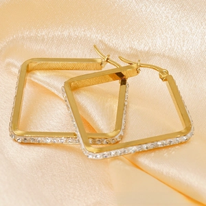 Detailed shot of gold-plated square hoop earrings with sparkling cubic zirconia inlay