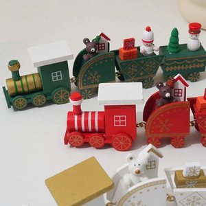 Macro shot of miniature wooden Christmas train carriages with snowmen and bear figures