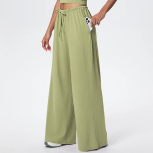 Detail of olive green wide-leg sports pants featuring side pocket and drawstring waist