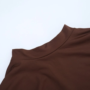 Close-up of the high neckline and precision stitching on this brown long-sleeve dress