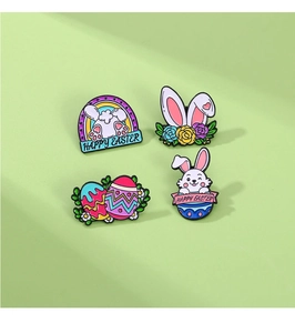 Set of four Easter metal pins featuring bunnies and eggs on a green background