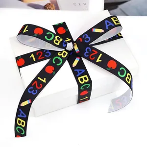 Black back-to-school ribbon with ABC 123 patterns tied on white gift box