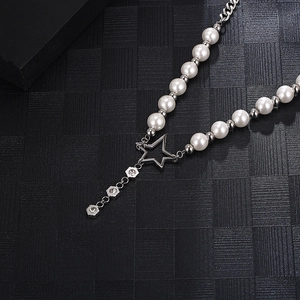 Detail of silver titanium chain with white pearls and sparkling star pendant design