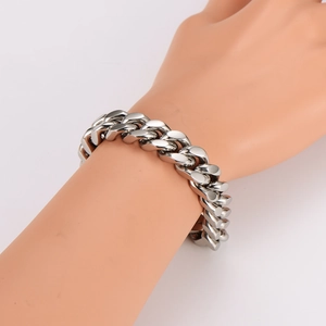 Silver stainless steel Cuban link bracelet for men on a mannequin wrist, classic bold design