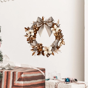 Christmas wreath wall sticker with golden bow and flowers on a white minimalist wall